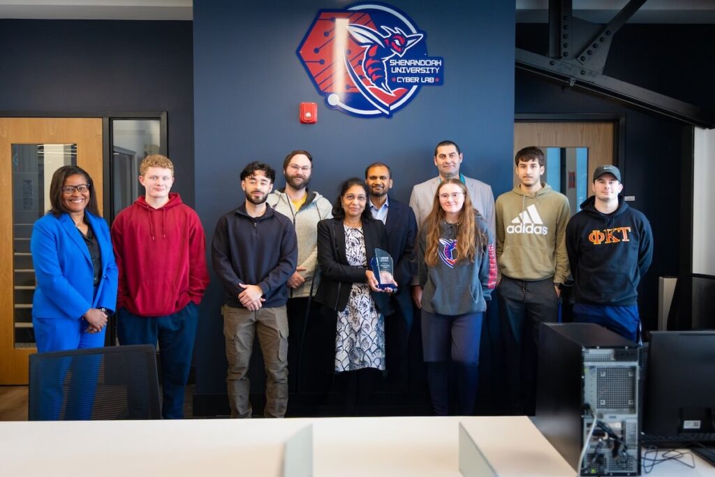 Shenandoah Creates Cybersecurity Lab Thanks To Generous Gift From Lingam Foundation Students, faculty and staff pose with Raj and Neeraja Lingam beneath a logo for the cybersecurity lab.