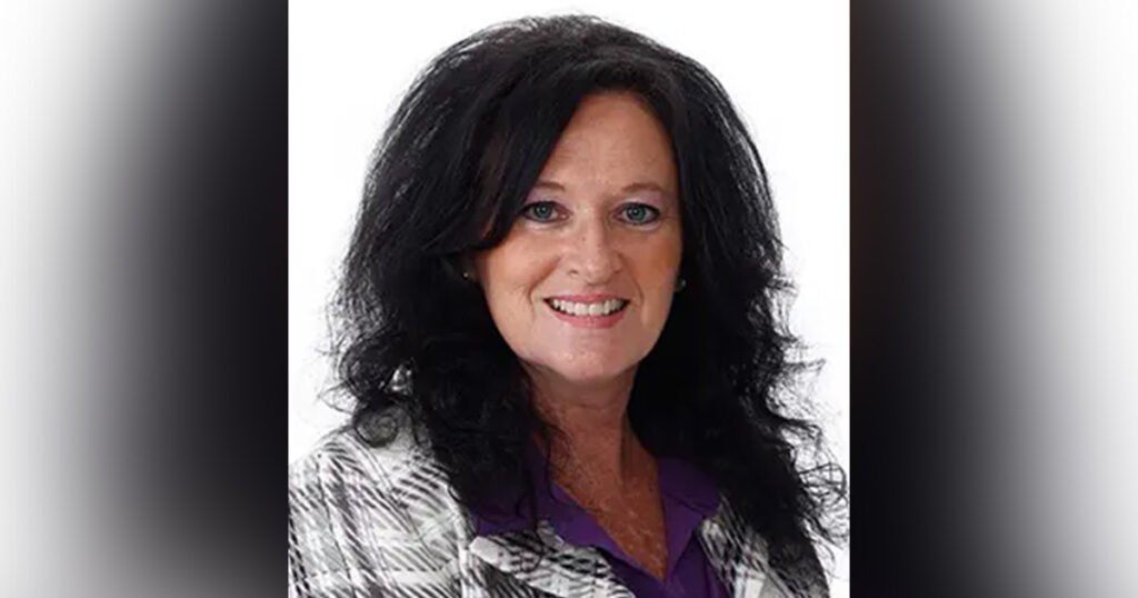 Dixie Denton Honored as Ball State’s Nominee for MAC Faculty Award Dixie Denton, a woman with medium-length black hair smiles and poses while wearing a white and gray plaid jacket and a purple shirt.